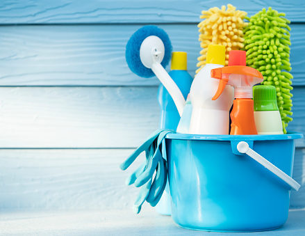 House cleaning product on wood table with blue background